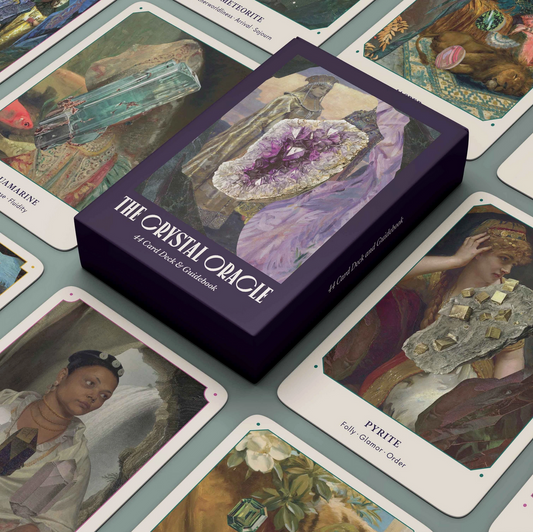 A box of 'The Crystal Oracle' card deck and guidebook is displayed alongside several cards laid out, each featuring artwork with a nature and mystical theme.